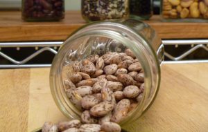 pinto beans spilling out of a jar