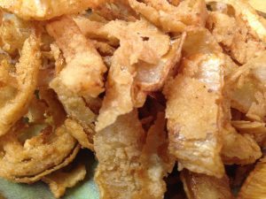 Crispy fried onion rings that are consumeable for vegans.